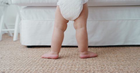 baby legs learning to walk toddler taking first steps wearing diaper cute infant walking at home 4k