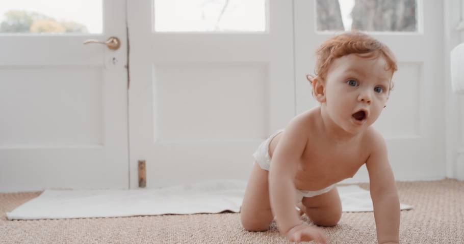 cute baby boy crawling toddler exploring with curiosity happy infant learning having fun enjoying childhood at home 4k Royalty-Free Stock Footage #1033025597