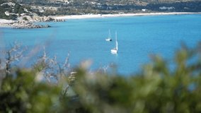 SLOW MOTION Sail boats anchored in blue water bay