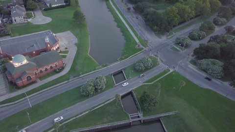 Drone Aerial of New Orleans Bayou St John Suburbian Neighborhood With Church River Canals And City Traffic