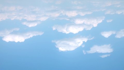 Blue clear sky, time lapse clouds, fast motion white rolling, building cloudscape in horizon, aerial view fluffy, puffy soft cloudscape after rain, summer lightness sunny day. /UHD.