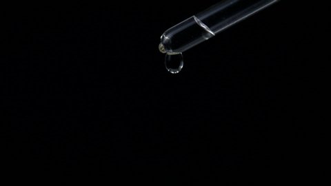 Water dropper in slow motion. Drop of water falling with dark / black background - high speed camera