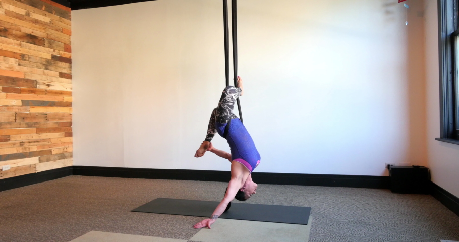 Mixed Race aerial yoga instructor working out on silks Royalty-Free Stock Footage #1033064258