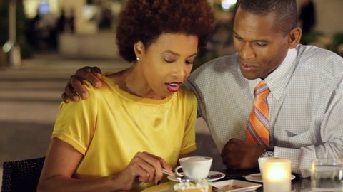 African American couple in cafe with dessert