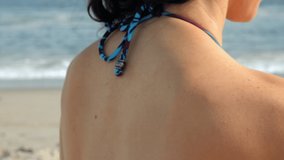 Woman applying sunscreen on beach