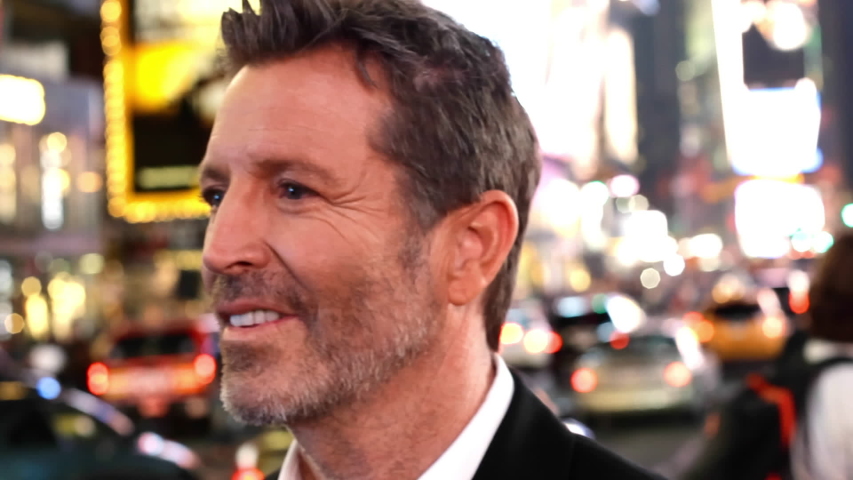 Close up of smiling man in busy city, New York, New York, United States