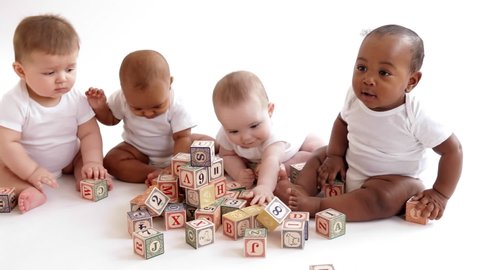 Babies playing with wooden blocks