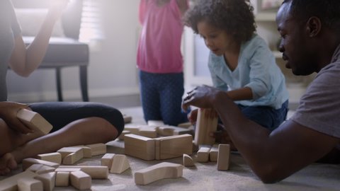 Family playing with building blocks in living room