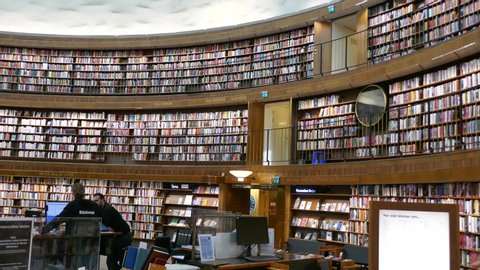 Stockholm, Sweden, Jul 2019: Right to left pan of people inside the National Library of Sweden Kungliga biblioteket