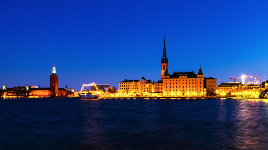 Stockholm, Sweden. Time-lapse of Gamla Stan in Stockholm, Sweden with landmarks like Riddarholm Church during the sunrise. View of old buildings and cloudy sky in morning, panning video