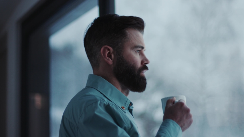 Close up handsome businessman drinking coffee and admire view standing by window in office   Royalty-Free Stock Footage #1033090097