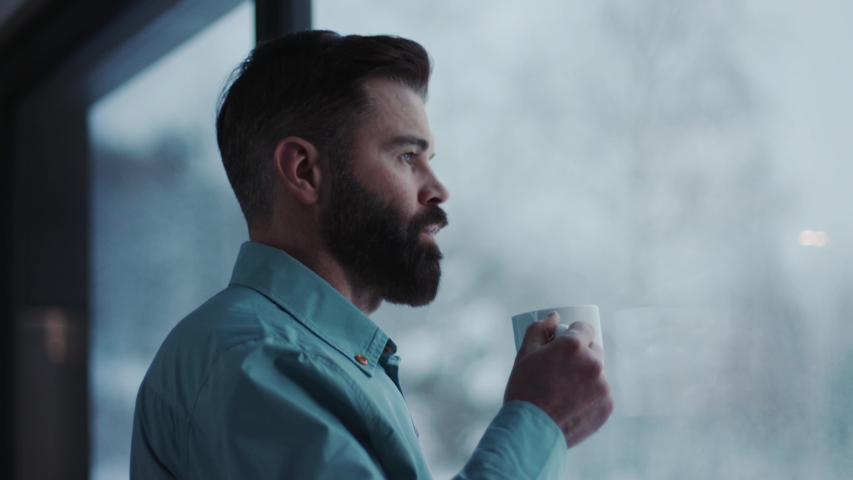Close up handsome businessman drinking coffee and admire view standing by window in office   Royalty-Free Stock Footage #1033090097