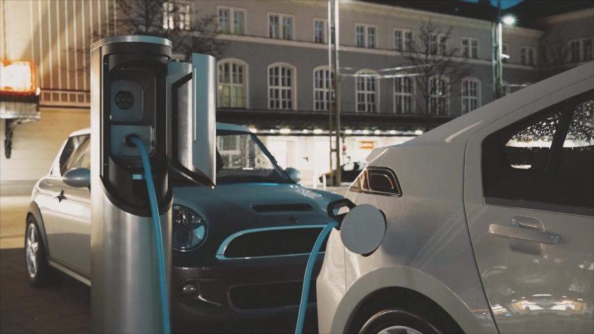 Electric Car Charging At A Charging Station (evening) Royalty-Free Stock Footage #1033094597