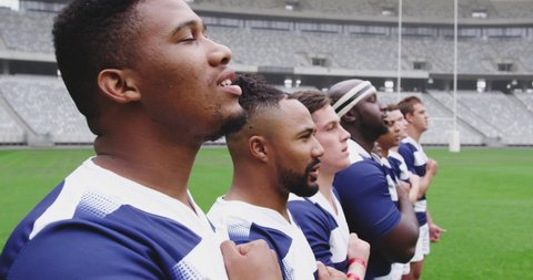 Close-up of diverse male rugby players taking pledge together in stadium. They are looking away in slow motion