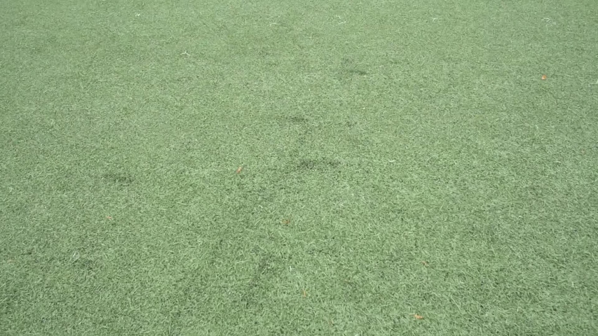 A soccer player shoots a soccer ball as a warmup before a soccer match