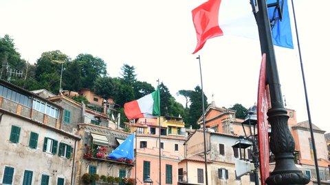flags of Italy and Europe waving in Nemi, Rome province