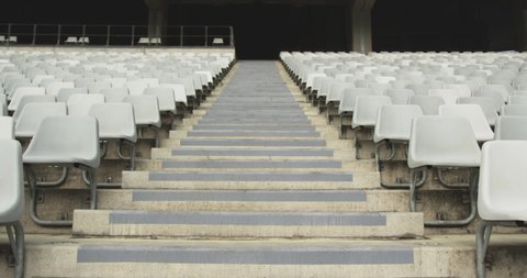 Low angle view of empty spectators seat in a stadium. Steps between spectators seat 4k