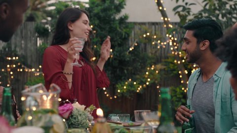 happy friends hugging celebrating reunion enjoying dinner party congratulating friend having fun evening together relaxing on weekend at home in backyard 4k footage