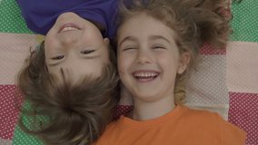 Friends selfie. Excited young children playing lying on the bed and taking a selfie. Little brother and sister monkeying on camera and kissing. Family taking a selfie with a smartphone. Close up. - Powered by Shutterstock - Get 15% off with code: PIKWIZARD15