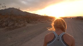 Sportive young woman jogging outdoors, trail running experience. People body conscious and heathy lifestyle concept; Girl running at sunset enjoying freedom