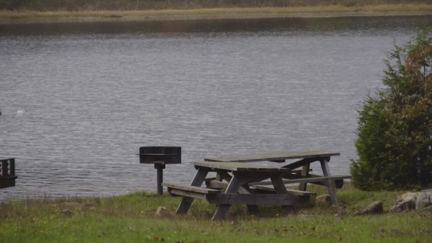 a picnic table by the lake during early fall