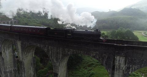 Ariel footage following the Jacobite steam train as it goes over the iconic Glenfinnan Viaduct in Scotland.