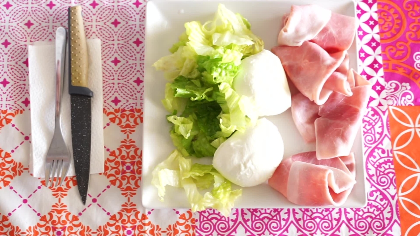 young man with beard eating roughly fresh food in a simple daylight atmosphere