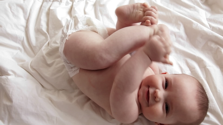 Caucasian baby rolling over, daytime Royalty-Free Stock Footage #1033119806