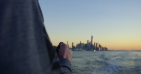 Male Model Photographing Beautiful Sunset and Beautiful Skyscrapers, Iconic Skyline In NYC On Hudson River Moving Away From Incredible New York Sunset