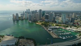 Aerial View Port of Miami and Down Town Showing Cruise Ships 
buildings, Marinas, Rivers with Boats and car Traffic on a Sunny Afternoon footage in 4K slowmo