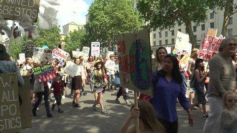LONDON, UK - MAY 24, 2019: Extinction Rebellion Climate Change protesters walking along the Whitehall, Parliament Square, chanting and shouting on the day when Theresa May resigned as Prime Minister
