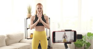 Female vlogger recording a video about warm up exercises