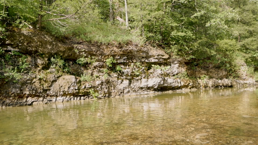 Reflection of ripples in a creek show up on a bluff 