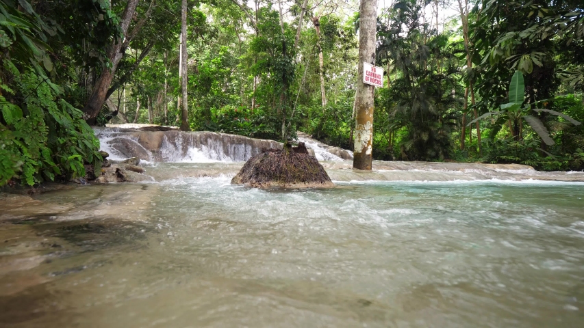 A low vantage point view of the rushing water and cascading waterfall rapids at Dunn