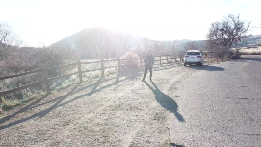AERIAL: extreme pull away from an anonymous figure lost within the giant boulders located at the Red Rocks Park in Colorado.