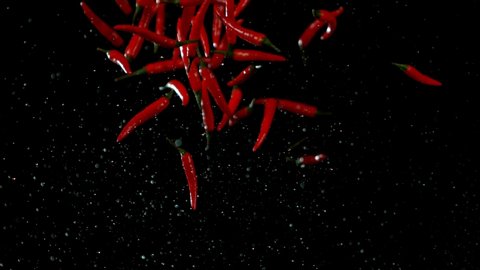 Super slow motion of flying red hot chilli peppers. Filmed on high speed cinema camera, 1000 fps