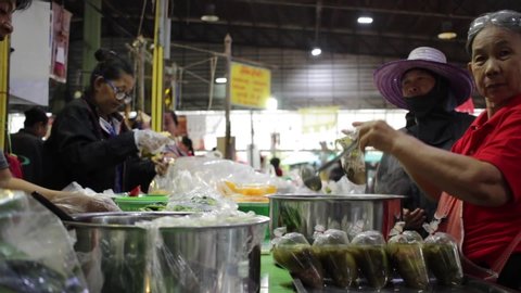 Banmai, Phitsanulok / Thailand - 12 29 2018: Market Vendor Ladles Soup Into Plastic Bags Banmai Fresh Market Phitsanulok Thailand