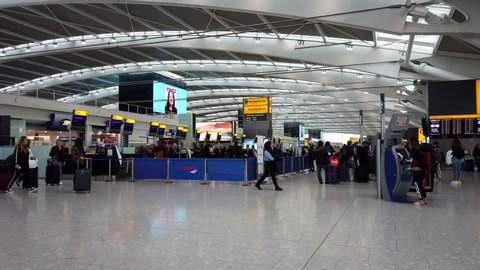 HEATHROW AIRPORT, LONDON - MARCH 16, 2019: Passengers check in for British Airways flights inside the departures level at Terminal 5, Heathrow International Airport in London, UK.