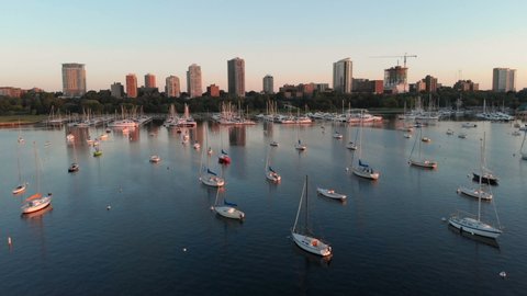 Aerial view of american city at dawn. High-rise  buildings, sailing yachts, boat dock. Sunny morning, summer. Milwaukee, Wisconsin, United States