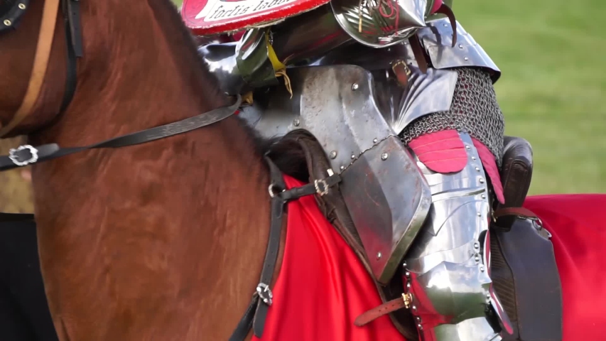 A medieval knight wering armour sitting on horseback