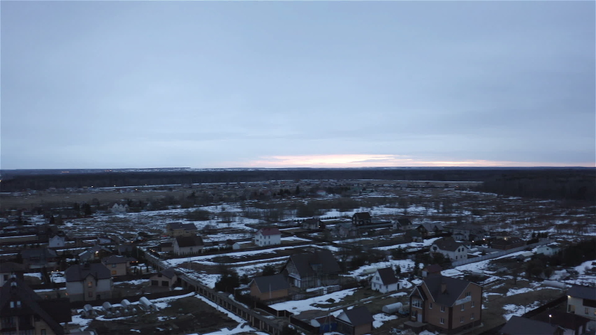 panorama of a country village with thawed snow on the ground.