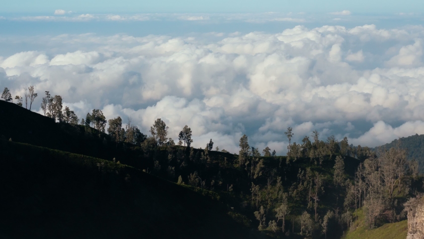 Timelapse of beautiful white clouds flying above the earth. View from above from Ijen volcano, East Jabva, Indonesia