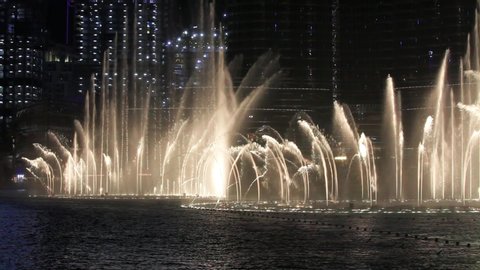 Dubai, UAE - July 1 2019 : 4k. Dubai Fountain at night, close up shot. Dance of the water. Illumination of Burj Khalifa and the fountain show in Dubai Mall. 