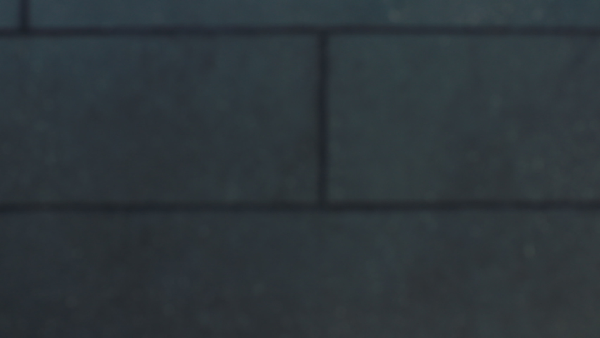 Young couple going outside from hi tech building together. Beautiful family holding hands near building exit. Happy man and woman going down stairs from luxury house.