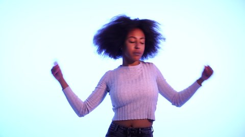 Video of Inspired cool African American woman dancing feeling the music and enjoying life on blue moody neon disco light background. In People, Music festival, Youth Party night lifestyle. 