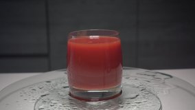conceptual creative tomato juice shoot slow motion videos on glass background water droplets different alternative angles compositions from each other.