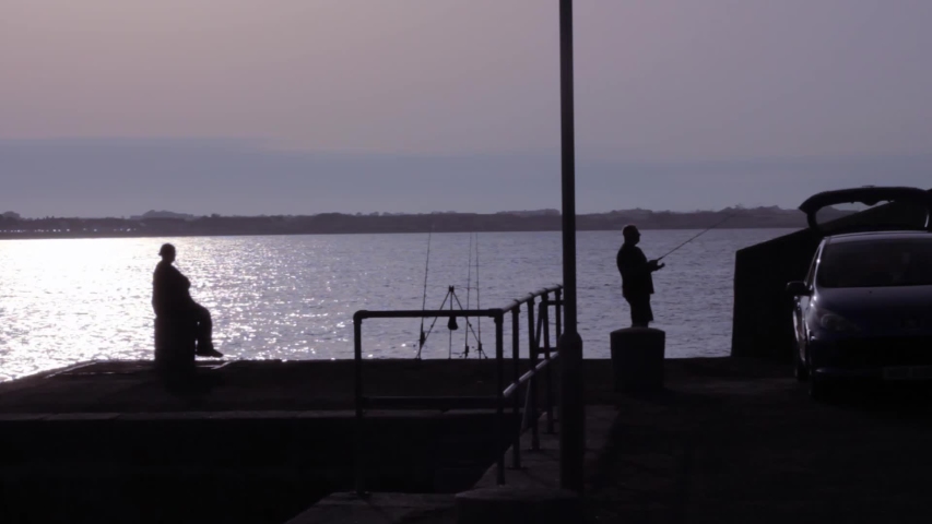 Pier fishing In harbour, evening.