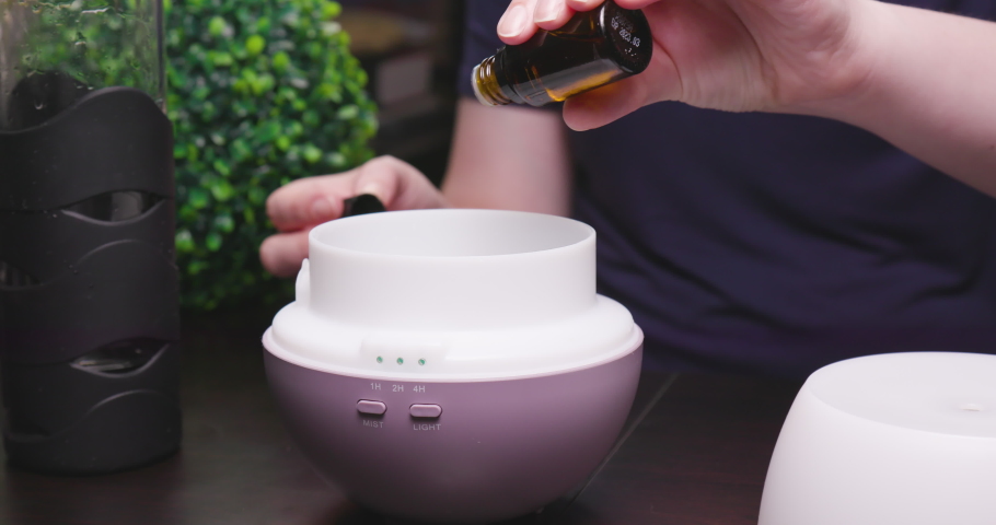Women Adding Essential Oils and Water to Diffuser | Shutterstock HD Video #1033232726