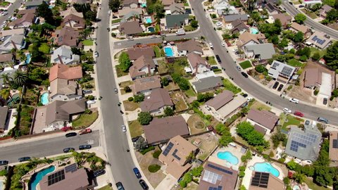 Aerial view suburban neighborhood with villas next to each other. San Diego, California, USA. Aerial view of residential modern subdivision luxury house with swimming pool.
