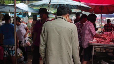 Banmai, Phitsanulok / Thailand - 12 30 2018: Two Men Walking Through Wat Bangsai Market Banmai Phitsanulok Thailand December 2018